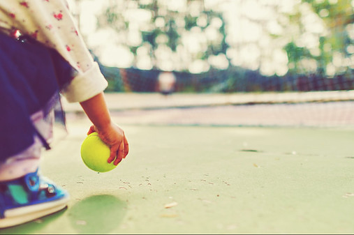 child pick up tennis ball